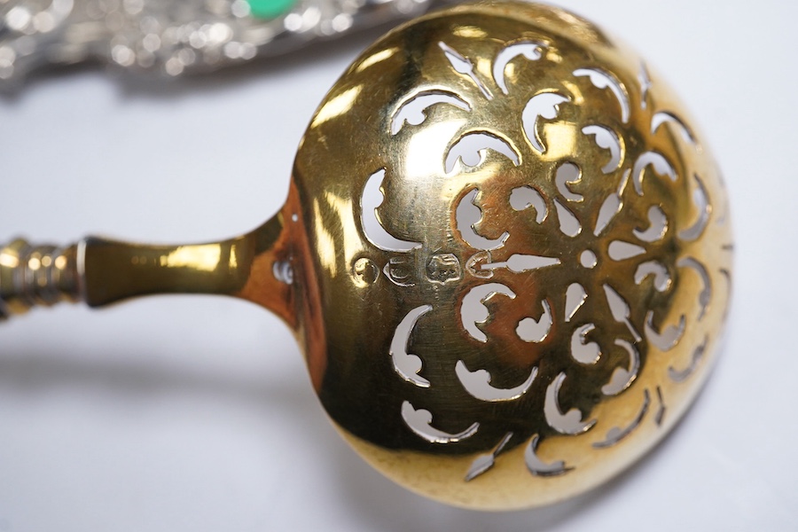 Two Victorian silver sugar bowls, a Victorian silver gilt sifter ladle and a repousse silver dish, 11.8oz. Condition - fair to good